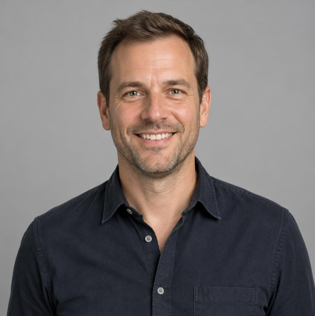 Portrait of a smiling man in a dark shirt